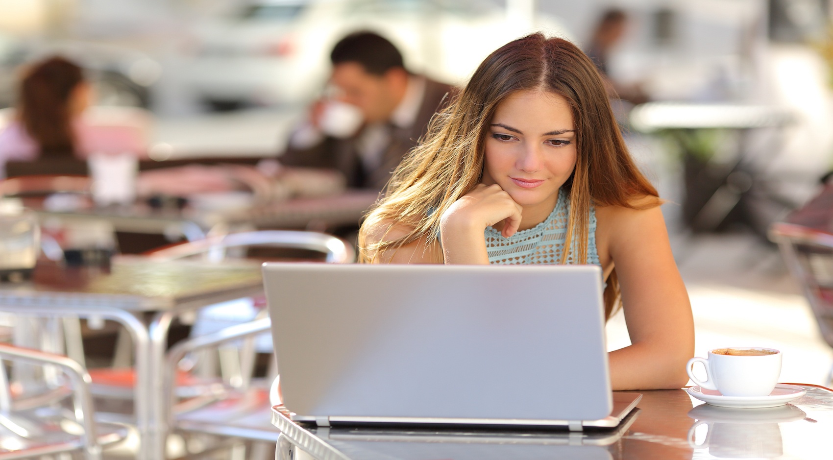 Woman at a cafe on her laptop 